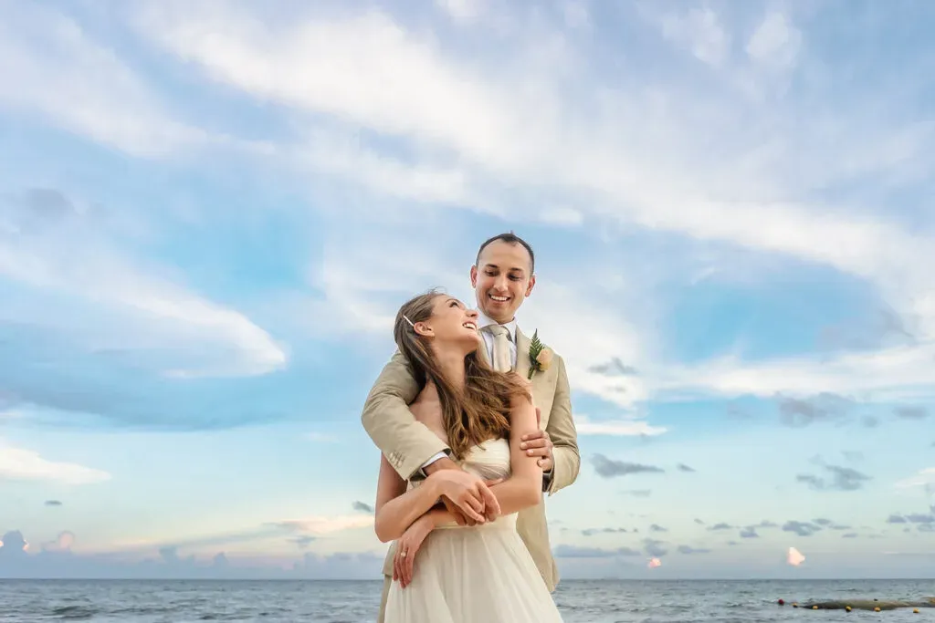 Romantic beach wedding couple embracing at sunset in Cancun Riviera Maya Mexico destination wedding photography