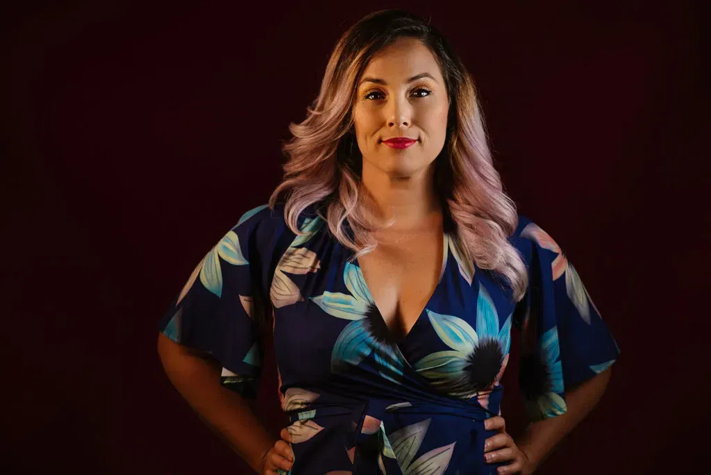 Professional wedding photographer in Cancun posing confidently in floral dress for Riviera Maya couples photography services