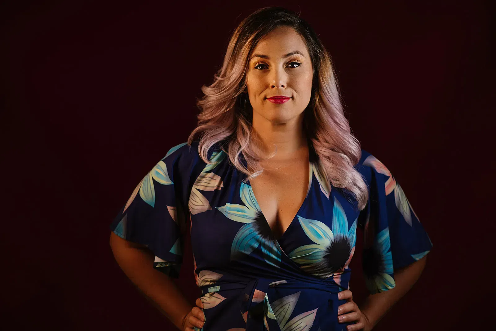 Professional wedding photographer in Cancun posing confidently in floral dress for Riviera Maya couples photography services