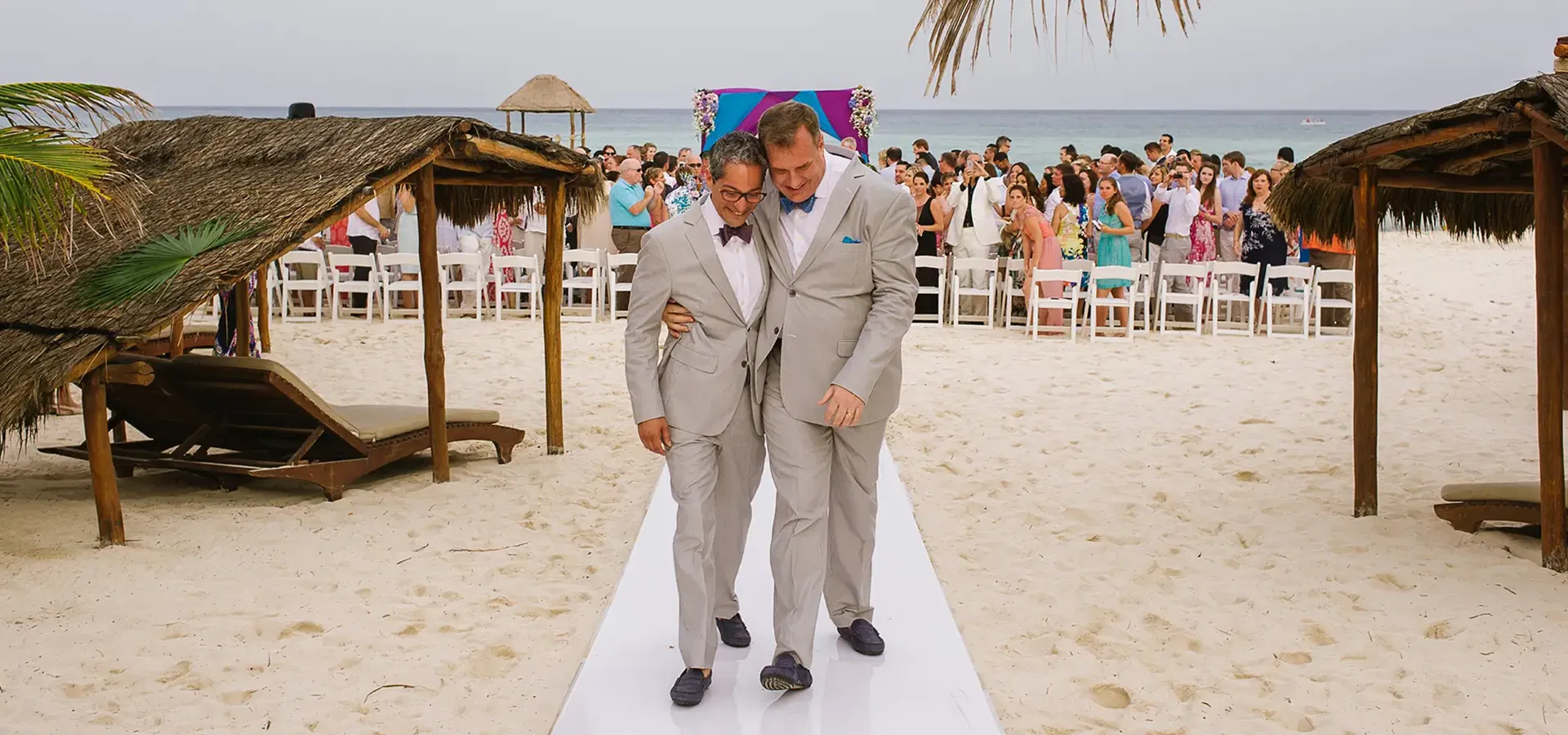 Same-sex wedding ceremony - two grooms walking down the aisle at Viceroy Riviera Maya by Tam Rico Photo
