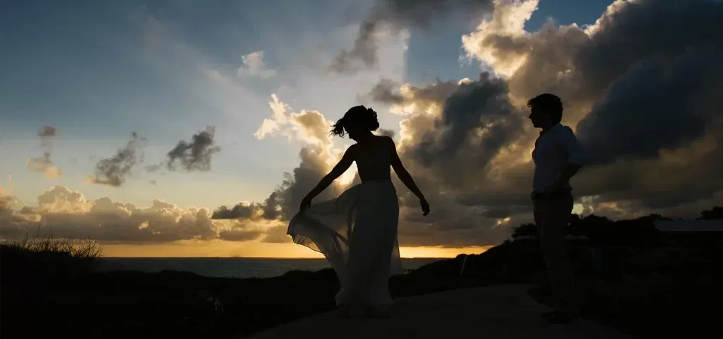 Romantic couple silhouette at sunset on Cancun beach - destination wedding photography in Riviera Maya Mexico