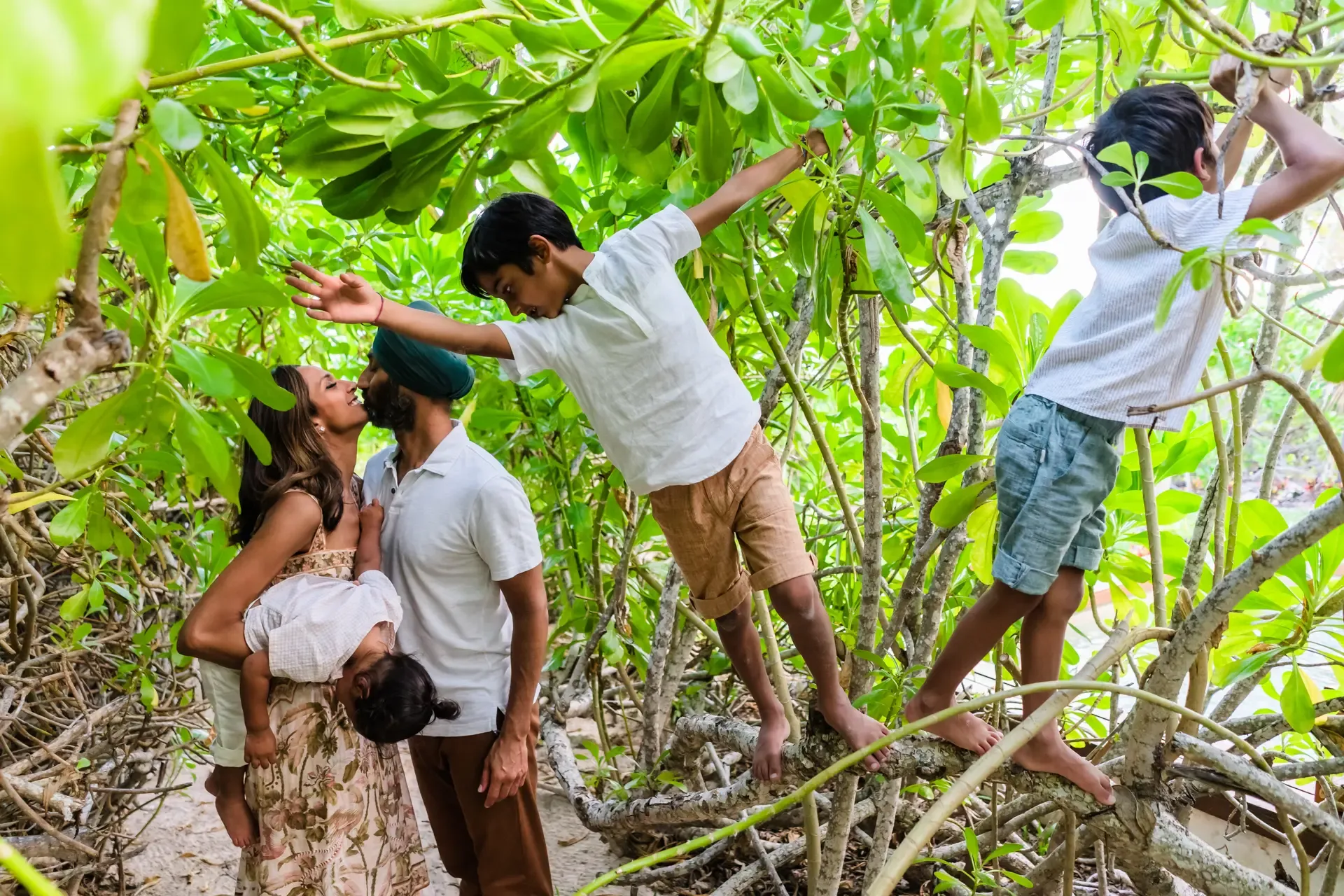 Couple exploring lush jungle mangroves during romantic engagement session in Riviera Maya Mexico destination wedding photography
