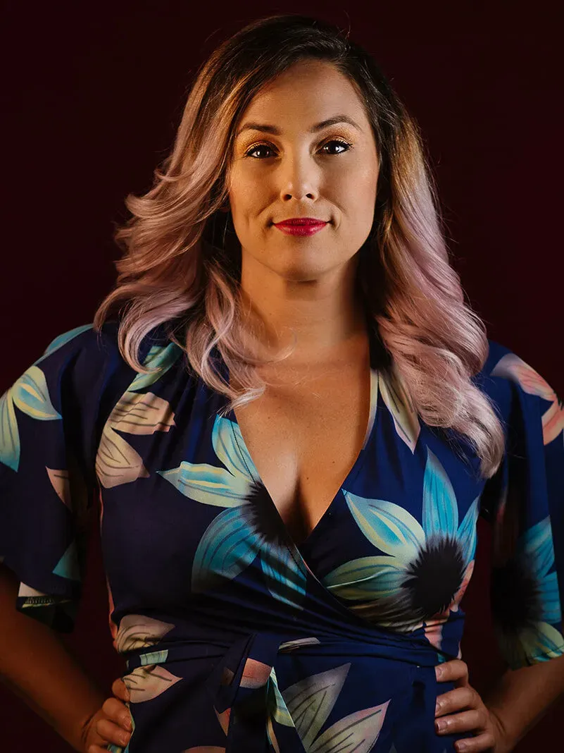 Tamara Rico AKA Tam Rico Photo doing a power pose looking at the camera and smiling