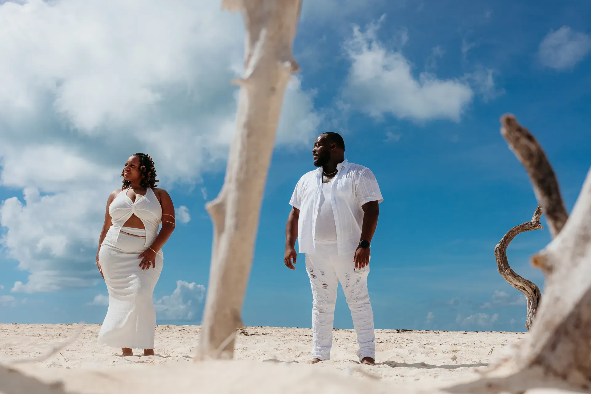 Fun engagement photography in Cancun, couple standing on the beach with dramatic sky