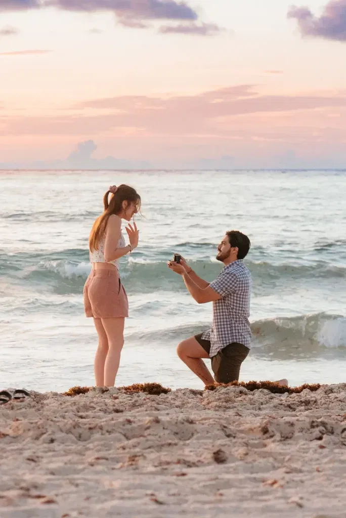 Beach proposal at sunset in Cancun - romantic couples photography session by the ocean waves in Riviera Maya Mexico