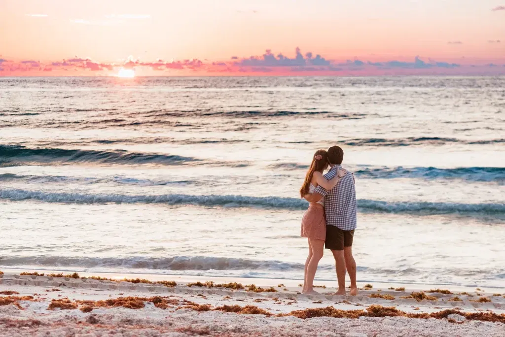 Romantic couple embracing on Cancun beach at sunset - wedding photography in Riviera Maya Mexico destination weddings