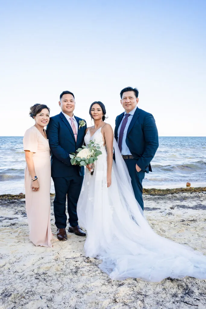 Beach wedding photography Cancun Riviera Maya bride groom family portrait ocean backdrop Mexico destination wedding