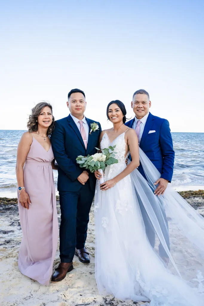 Beach wedding photography Cancun - bride groom family portrait ocean backdrop Riviera Maya Mexico destination wedding