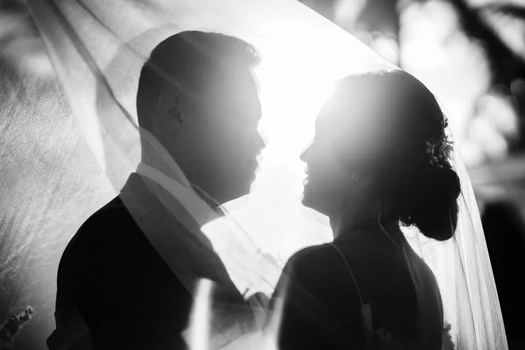 Romantic bride and groom silhouette portrait in dramatic lighting at Cancun Riviera Maya destination wedding Mexico