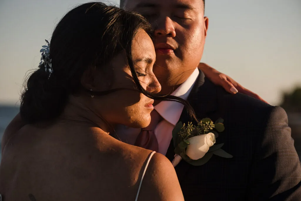 Romantic couple embracing during golden hour wedding photography session in Cancun Riviera Maya Mexico destination wedding