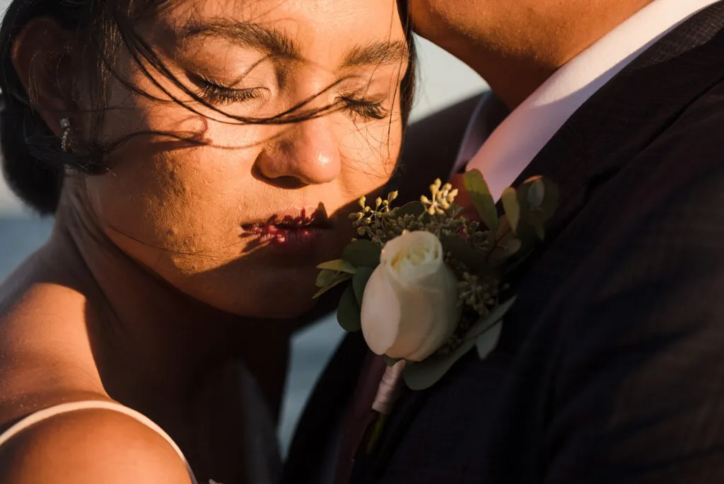 Intimate wedding couple portrait in golden hour light with boutonniere, Cancun Riviera Maya destination wedding photography