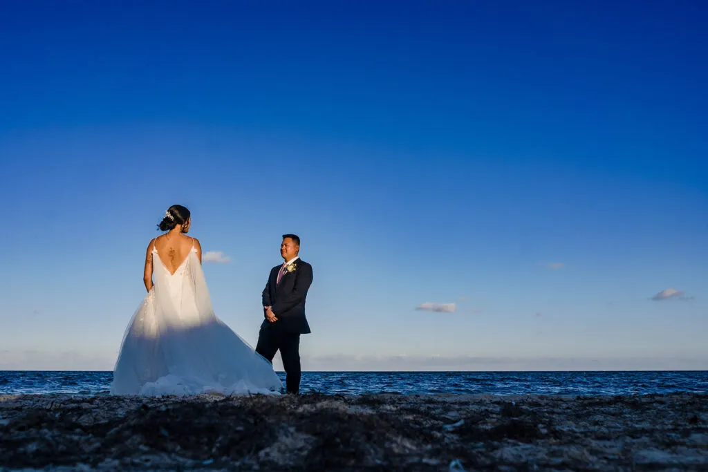 Bride and groom wedding portrait on Cancun beach at sunset with ocean view in Riviera Maya Mexico destination wedding