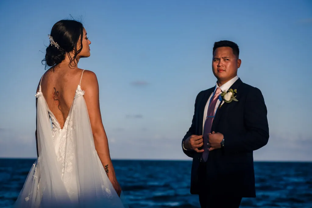 Bride and groom wedding portrait at sunset on Cancun beach with ocean backdrop in Riviera Maya Mexico destination wedding