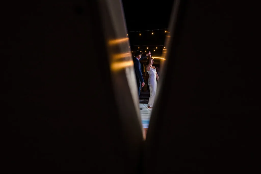 Romantic couple portrait through architectural frame with string lights in Cancun Riviera Maya Mexico wedding photography