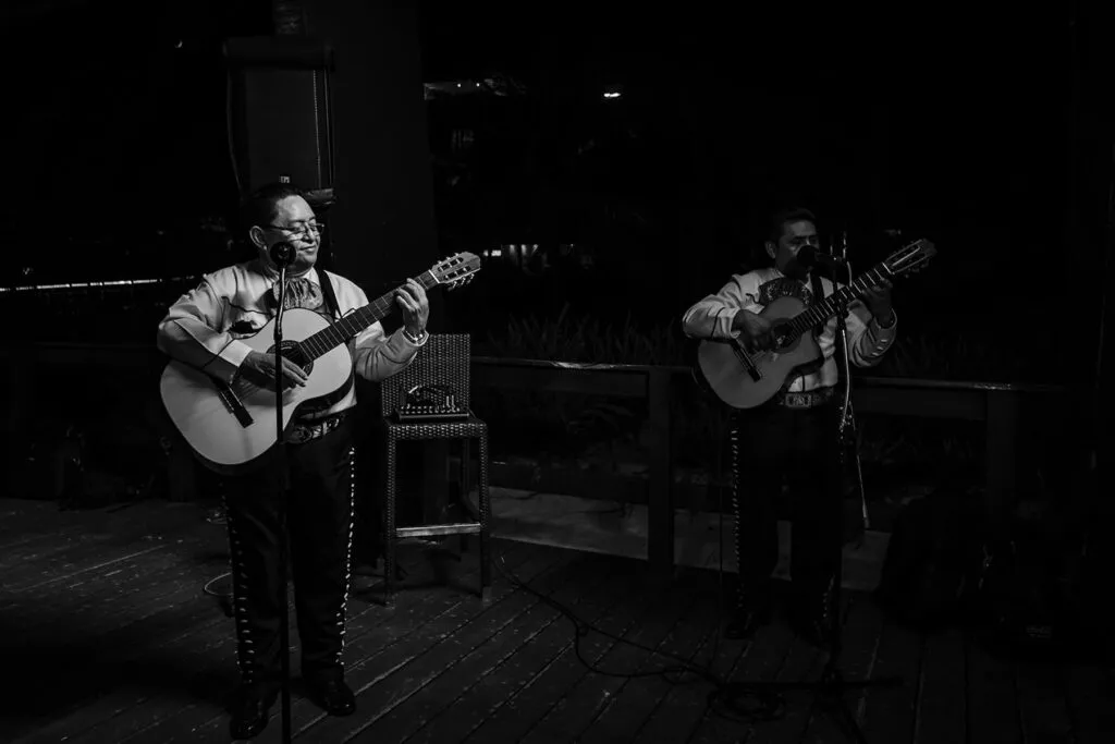 Two mariachi musicians performing acoustic guitars at romantic Cancun wedding reception in Riviera Maya Mexico