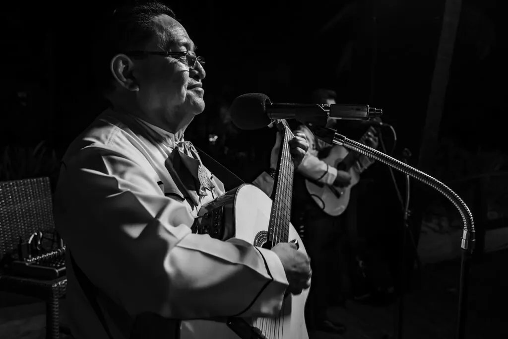 Mariachi guitarist performing at wedding reception in Cancun Mexico - traditional Mexican wedding entertainment