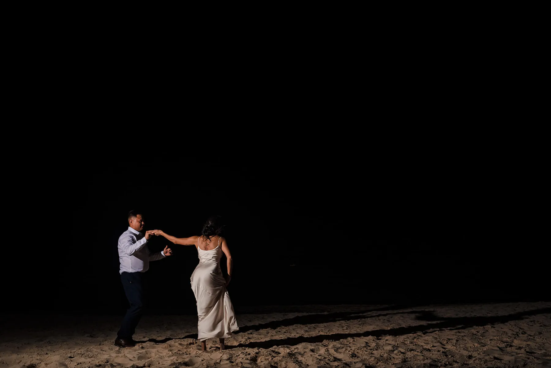 Romantic couple dancing on beach at night in Cancun Mexico destination wedding photography Riviera Maya