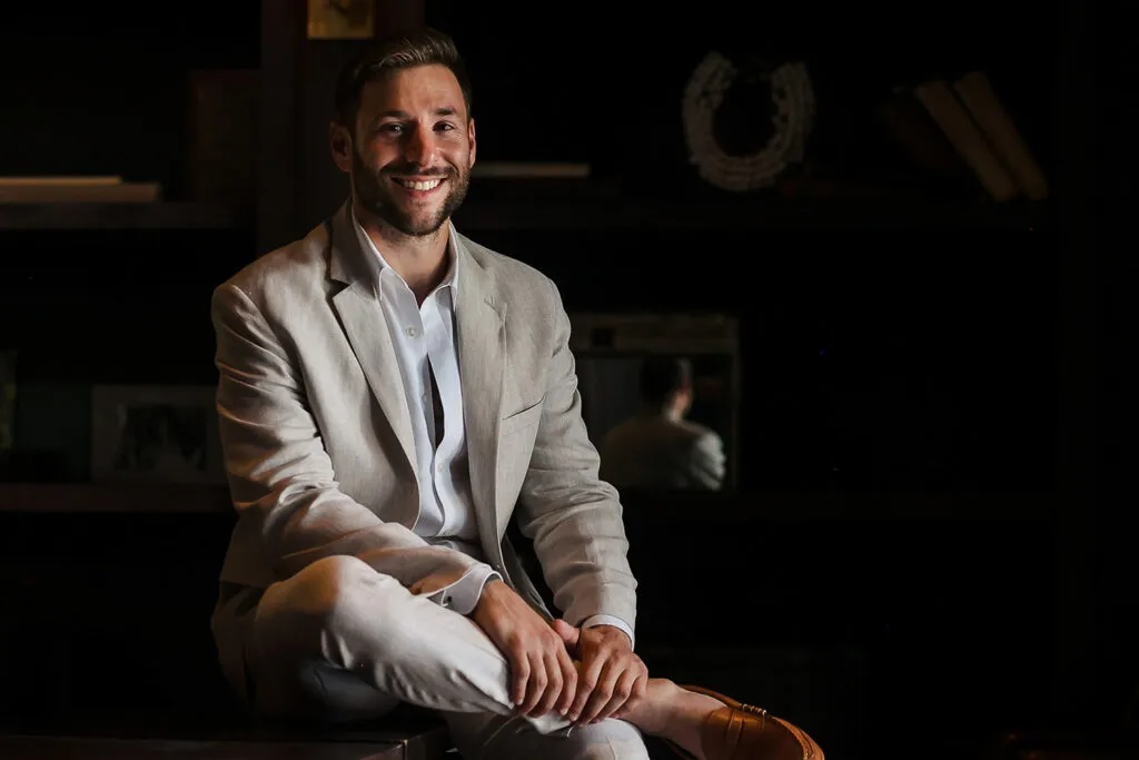 Cancun wedding photographer in beige suit smiling in studio - professional couples photography Riviera Maya Mexico