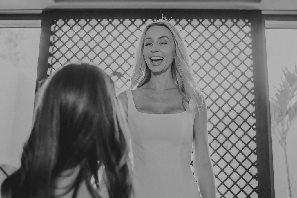 Bride laughing joyfully during wedding preparation moment in Cancun Riviera Maya destination wedding photography