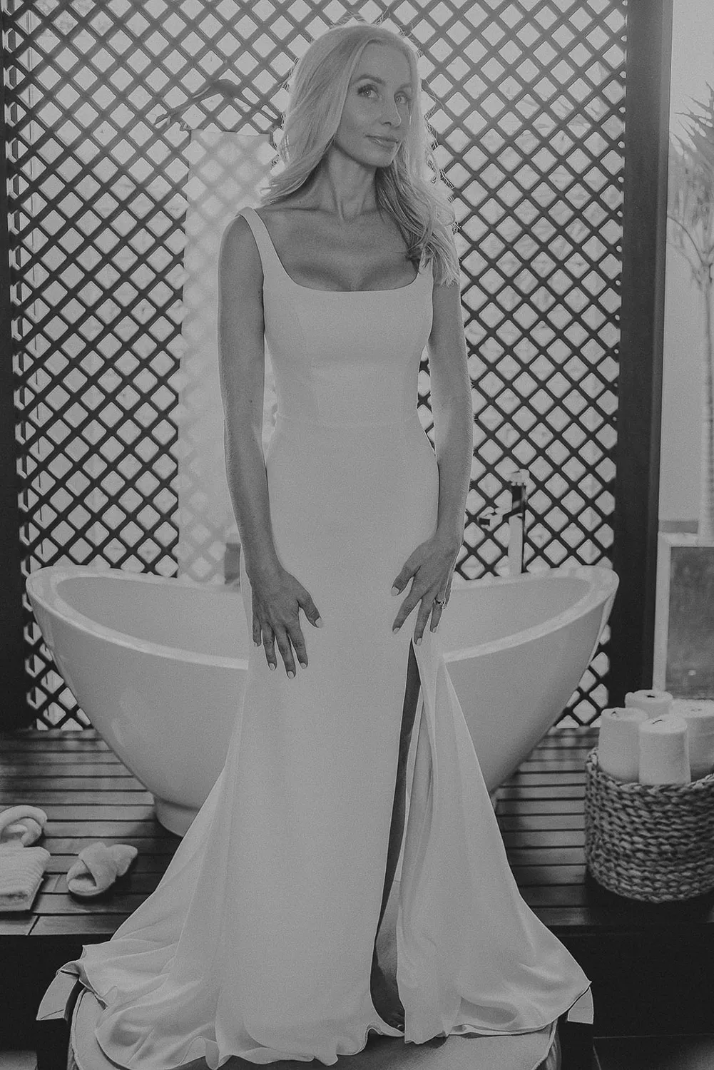 Elegant bride in fitted wedding dress posing by bathtub at luxury Riviera Maya resort venue in Cancun Mexico