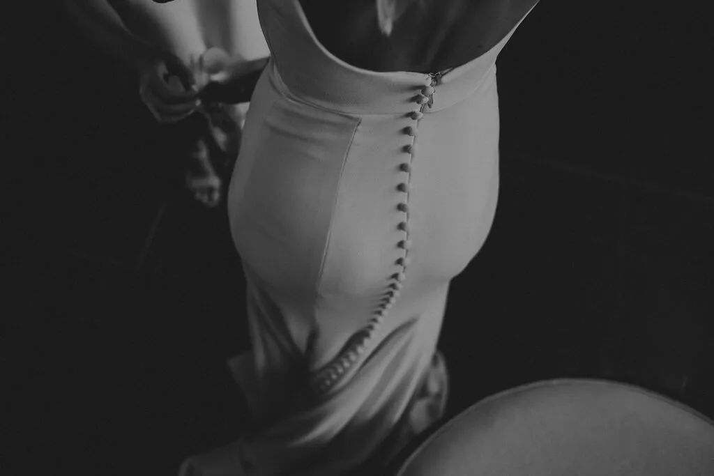 Bride getting ready in Cancun wedding dress with elegant button details - Riviera Maya destination wedding photography