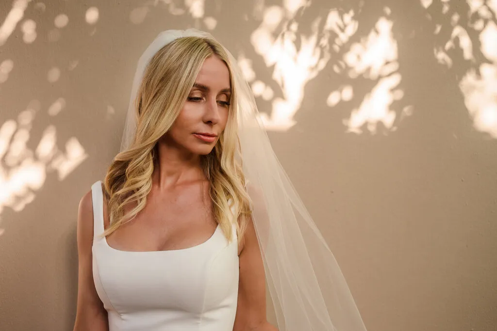 Elegant bride in white dress and veil with romantic lighting for Cancun Riviera Maya wedding photography session