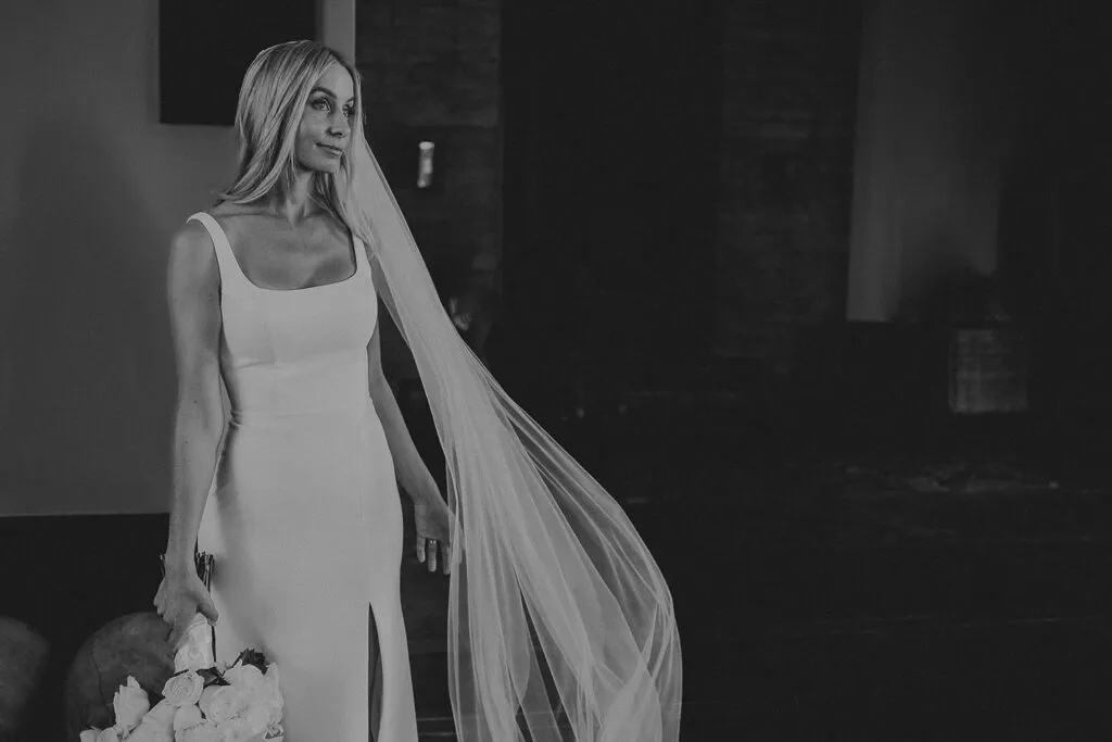 Elegant bride in fitted wedding dress with flowing veil at luxury Riviera Maya resort in Cancun Mexico destination wedding