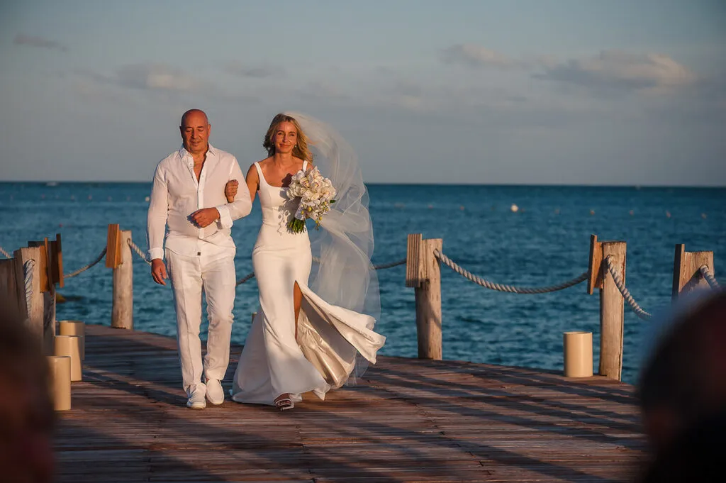 Bride and father walking down wooden pier at beach wedding ceremony in Cancun Riviera Maya Mexico destination wedding