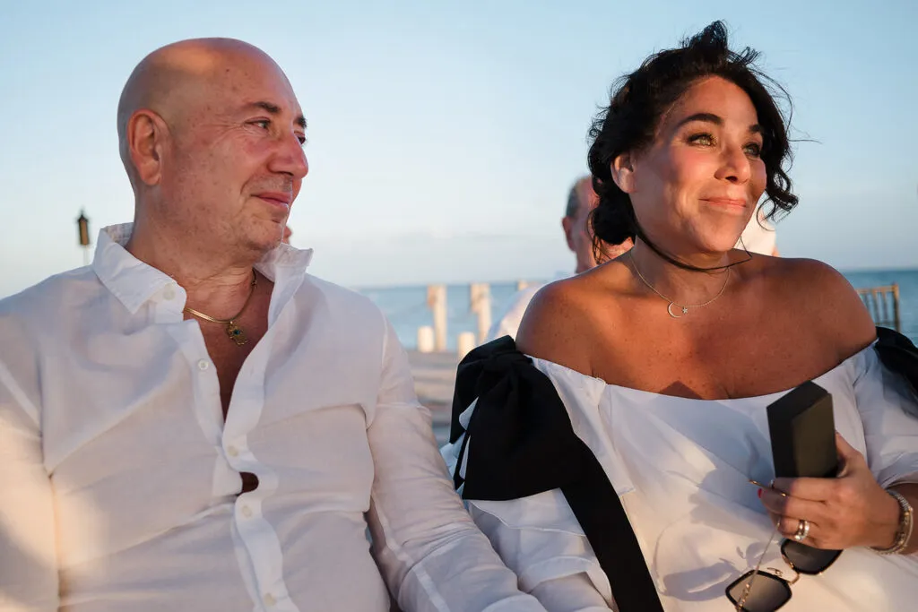 Romantic couple celebrating beach wedding in Cancun at sunset - destination wedding photography Riviera Maya Mexico