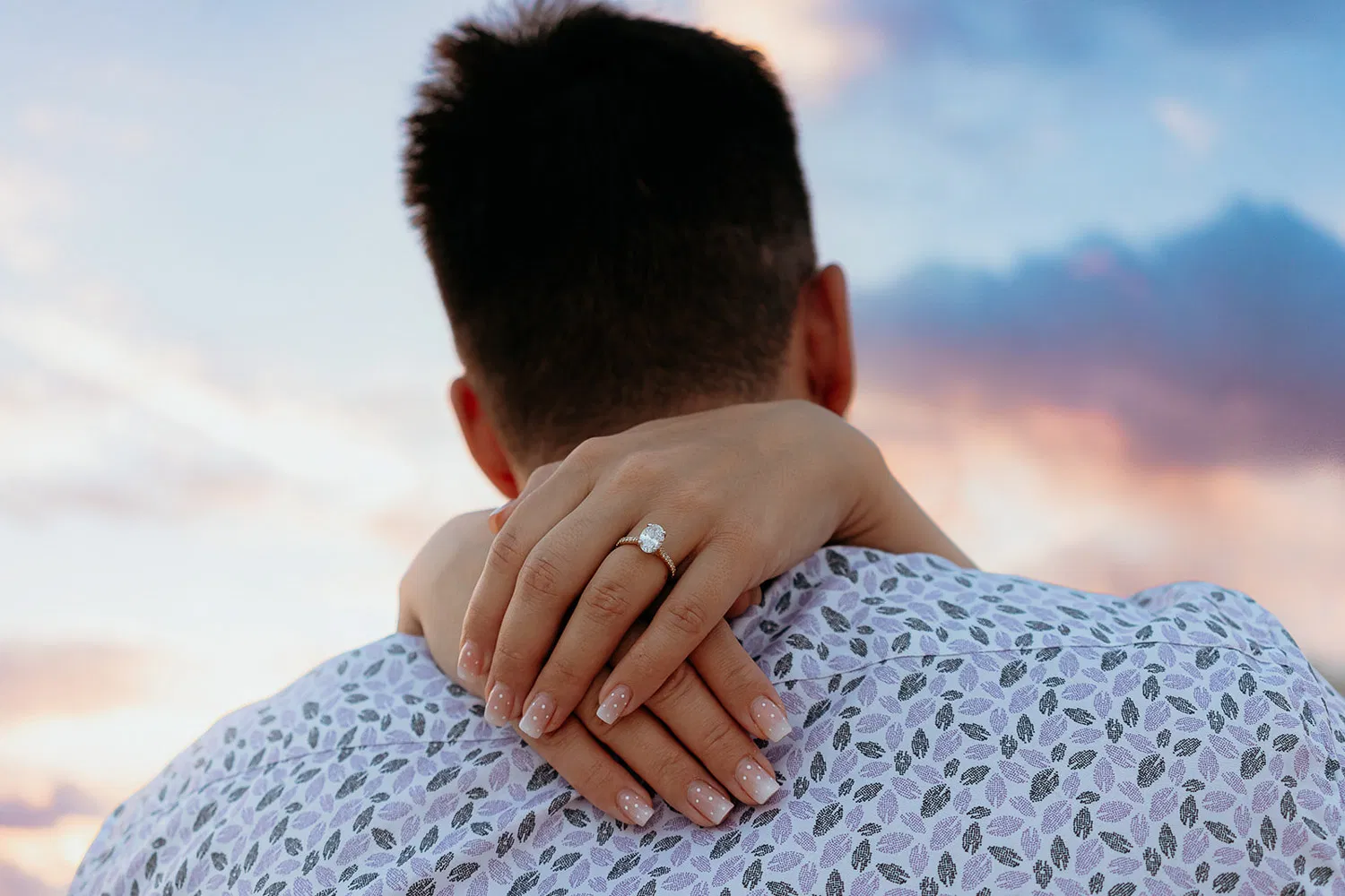 Engaged couple embracing at golden hour in Cancun showing engagement ring after surprise proposal by Tam Rico Photo