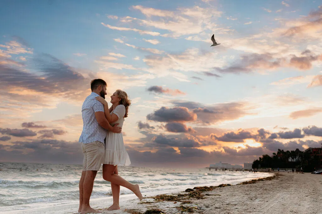 Romantic couple embracing on Cancun beach at sunrise during proposal photoshoot in Cancun Mexico