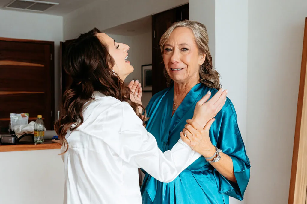 Mother of bride getting ready in silk robe with wedding photographer in Cancun Riviera Maya Mexico destination wedding