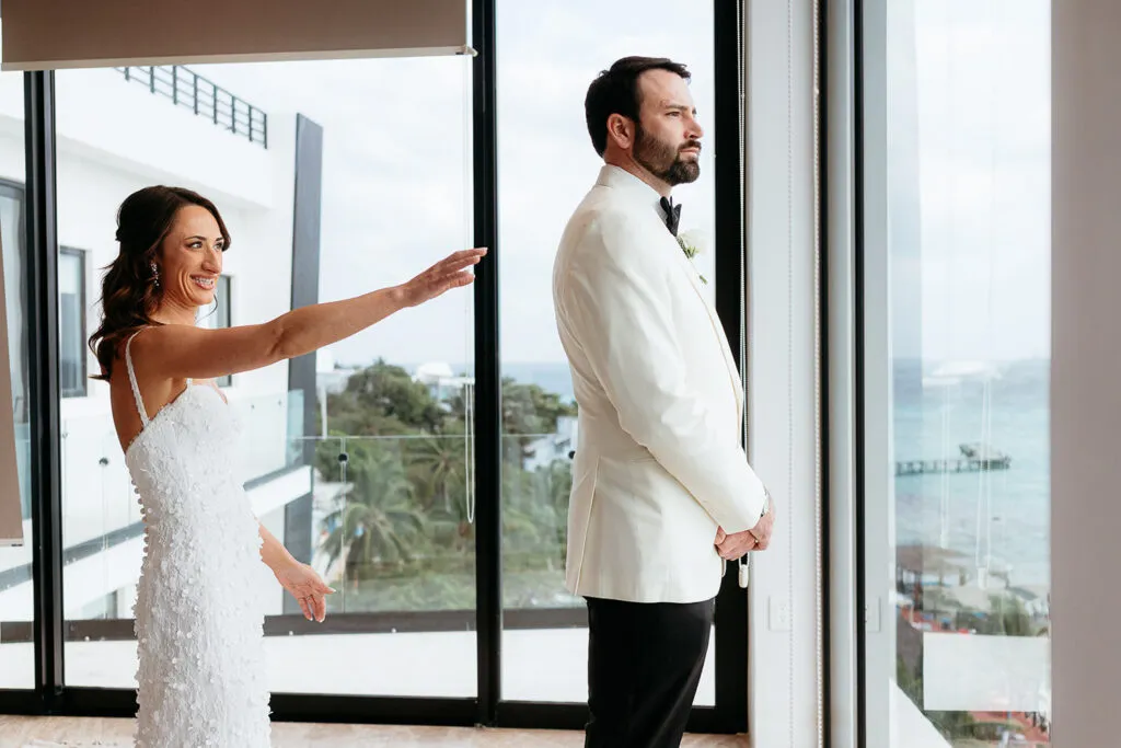 Bride and groom first look moment at luxury Cancun wedding venue with ocean view - Riviera Maya wedding photography