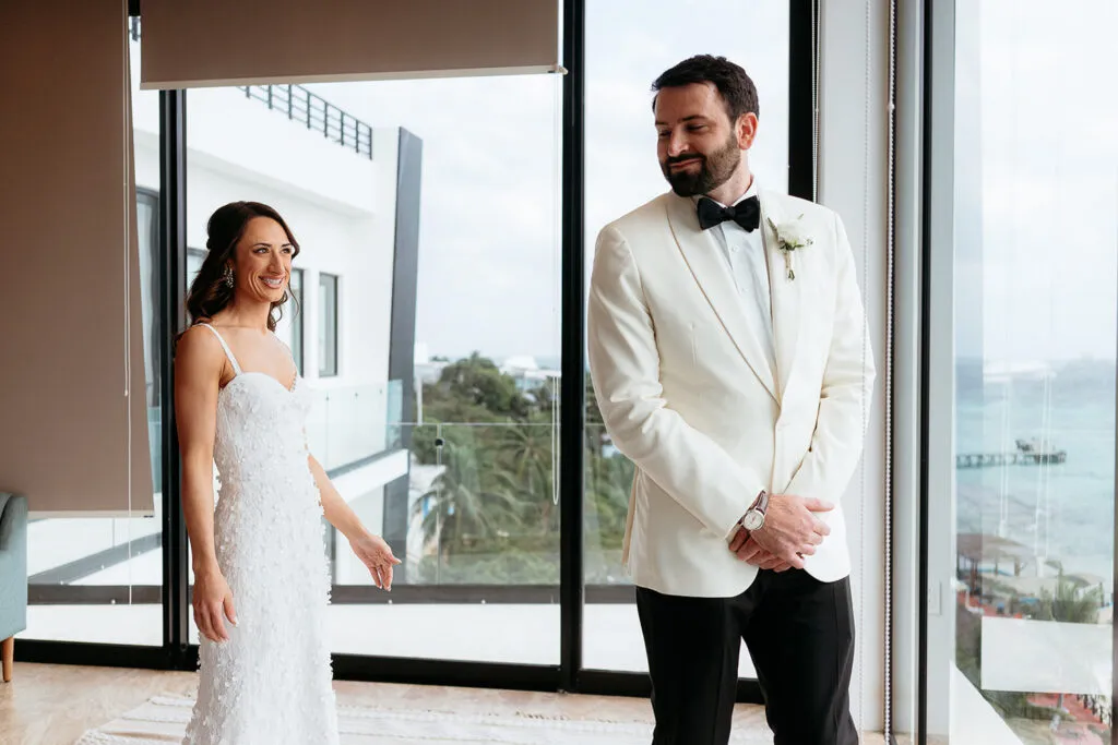 Elegant bride and groom first look moment at luxury Cancun resort with ocean views - Riviera Maya wedding photography