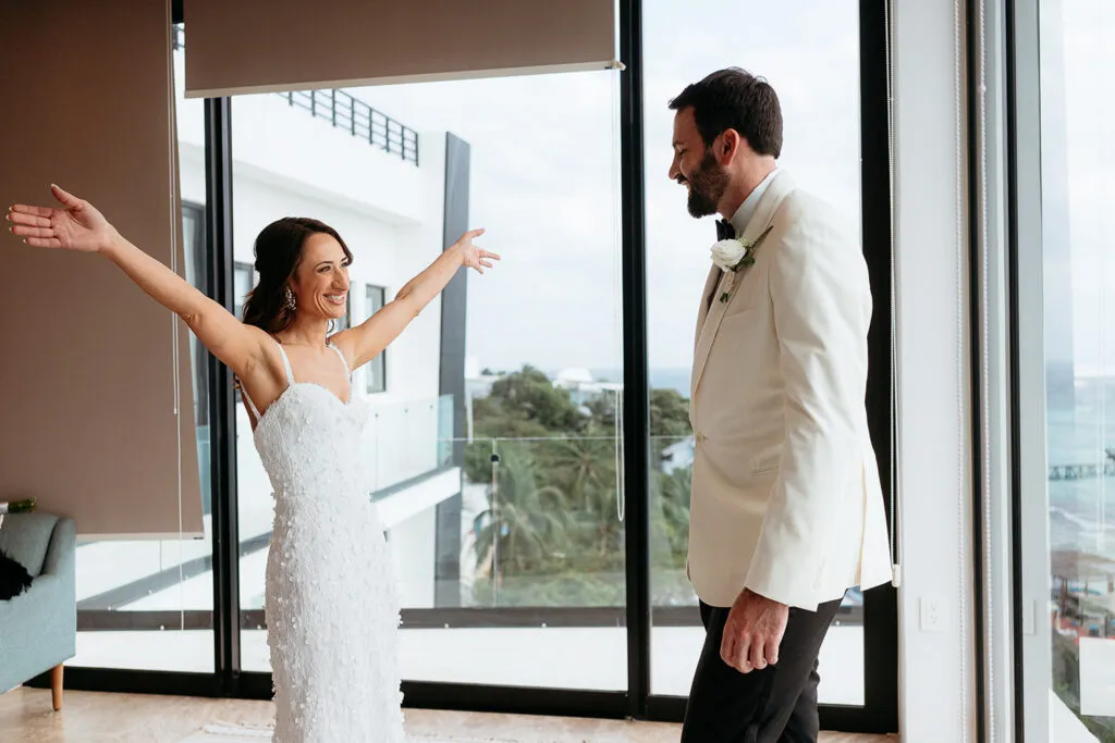 Bride and groom first look moment at luxury Cancun resort with ocean views - destination wedding photography Riviera Maya