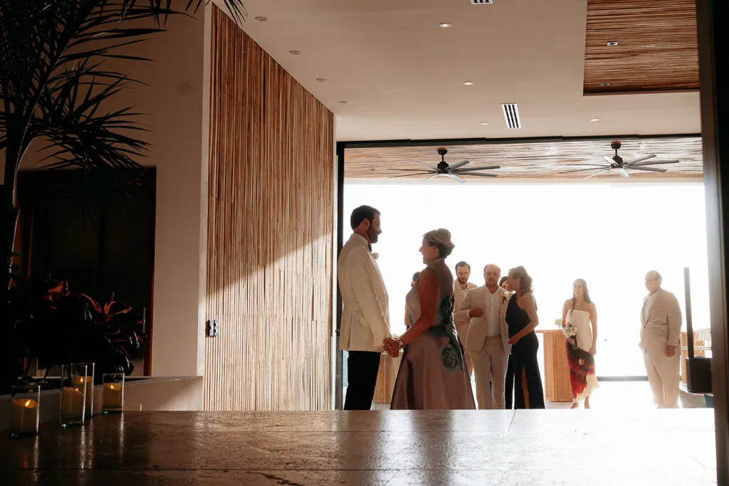Intimate wedding ceremony at luxury resort in Cancun with couple exchanging vows overlooking Caribbean Sea in Riviera Maya