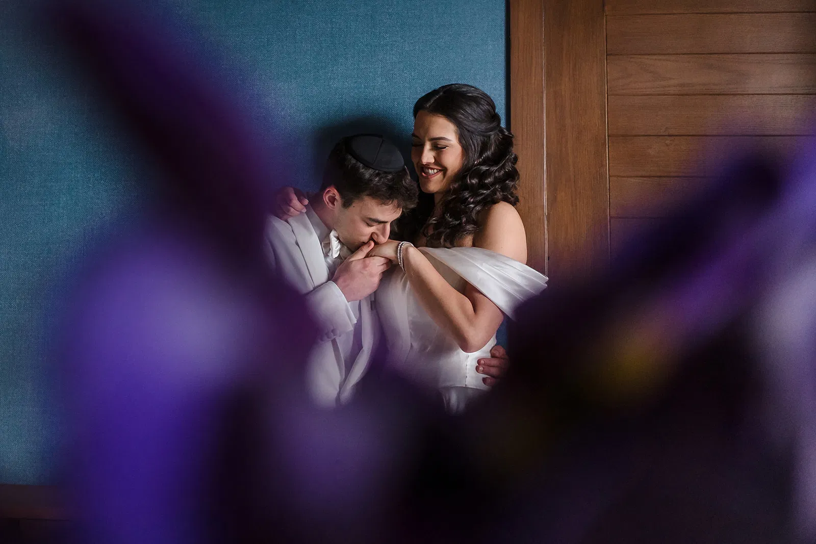 Groom kissing bride's hand in intimate moment at Dreams Natura Resort wedding in Cancun by Tam Rico Photo