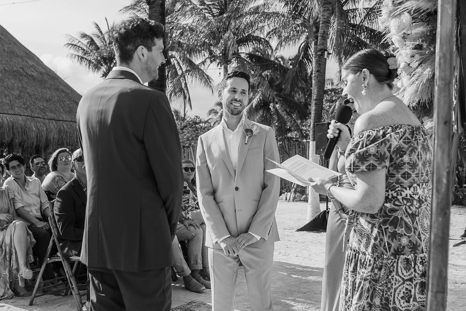 Groom smiling during tropical beach wedding ceremony at Blue Venado Riviera Maya Mexico by Tam Rico Photo