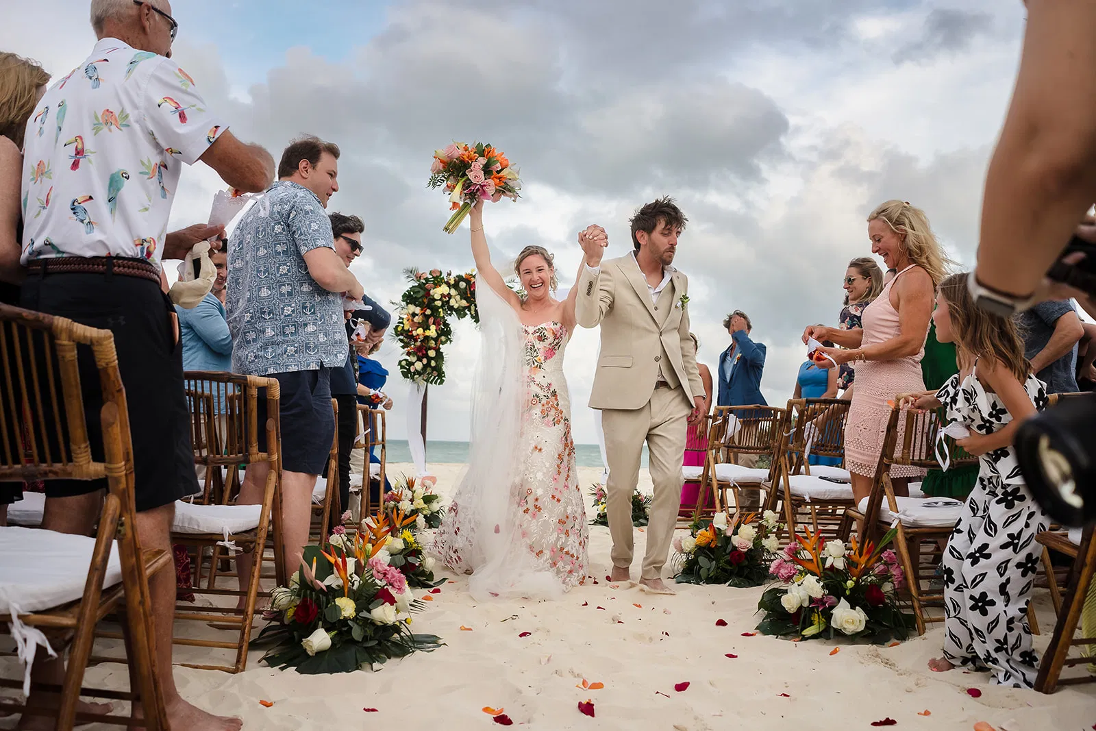 Couple celebrating walking down aisle after ceremony at Dreams Playa Mujeres wedding in Cancun by Tam Rico Photo