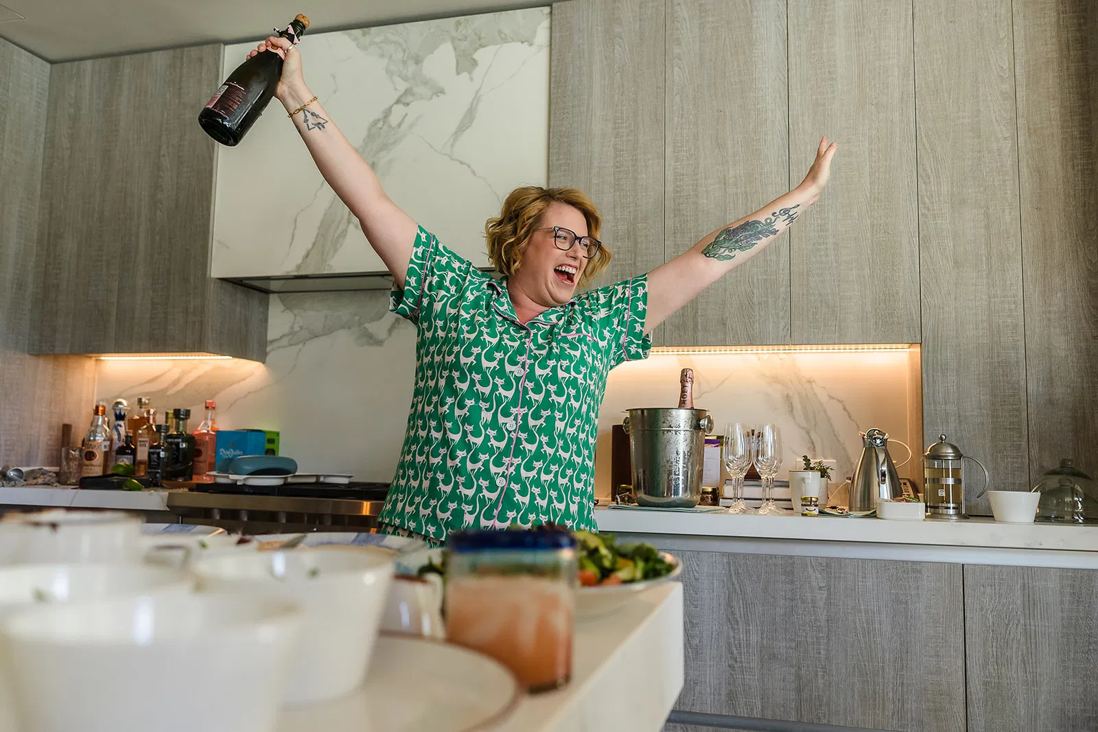 LGBTQ couple celebrating same-sex wedding at Rosewood Mayakoba with champagne in luxury Cancun Riviera Maya kitchen suite