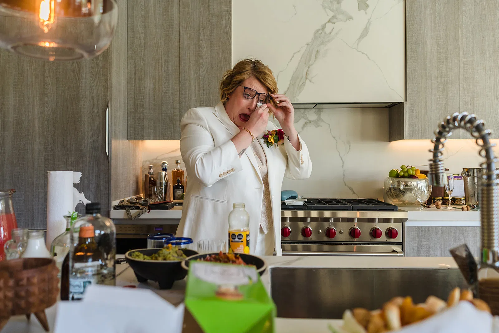 LGBTQ bride emotional moment during wedding preparation at Rosewood Mayakoba luxury resort kitchen in Riviera Maya Mexico