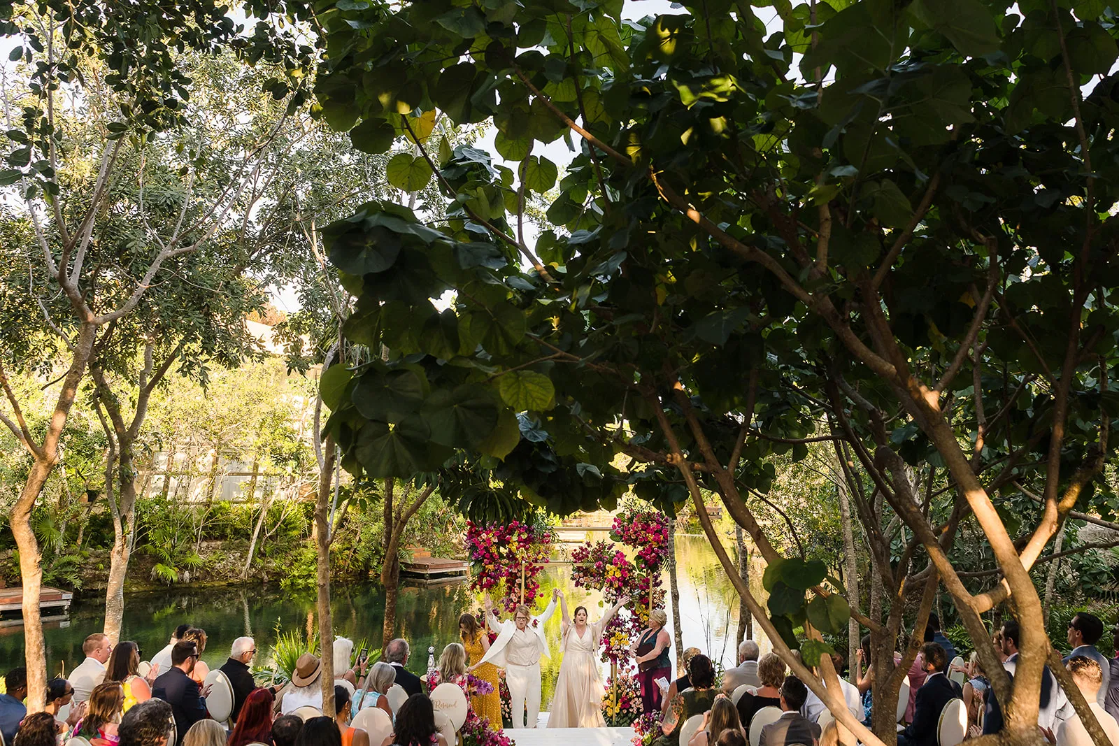 LGBTQ wedding ceremony at Rosewood Mayakoba with couple celebrating under lush canopy, Riviera Maya destination wedding photography