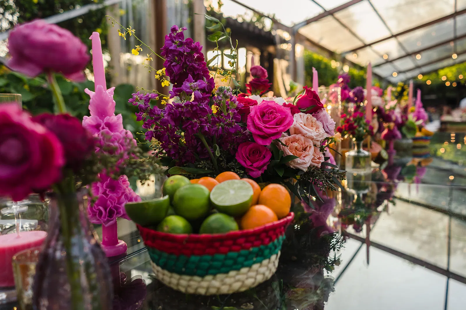 LGBTQ wedding centerpiece with vibrant flowers and citrus fruits at Rosewood Mayakoba same-sex celebration in Riviera Maya