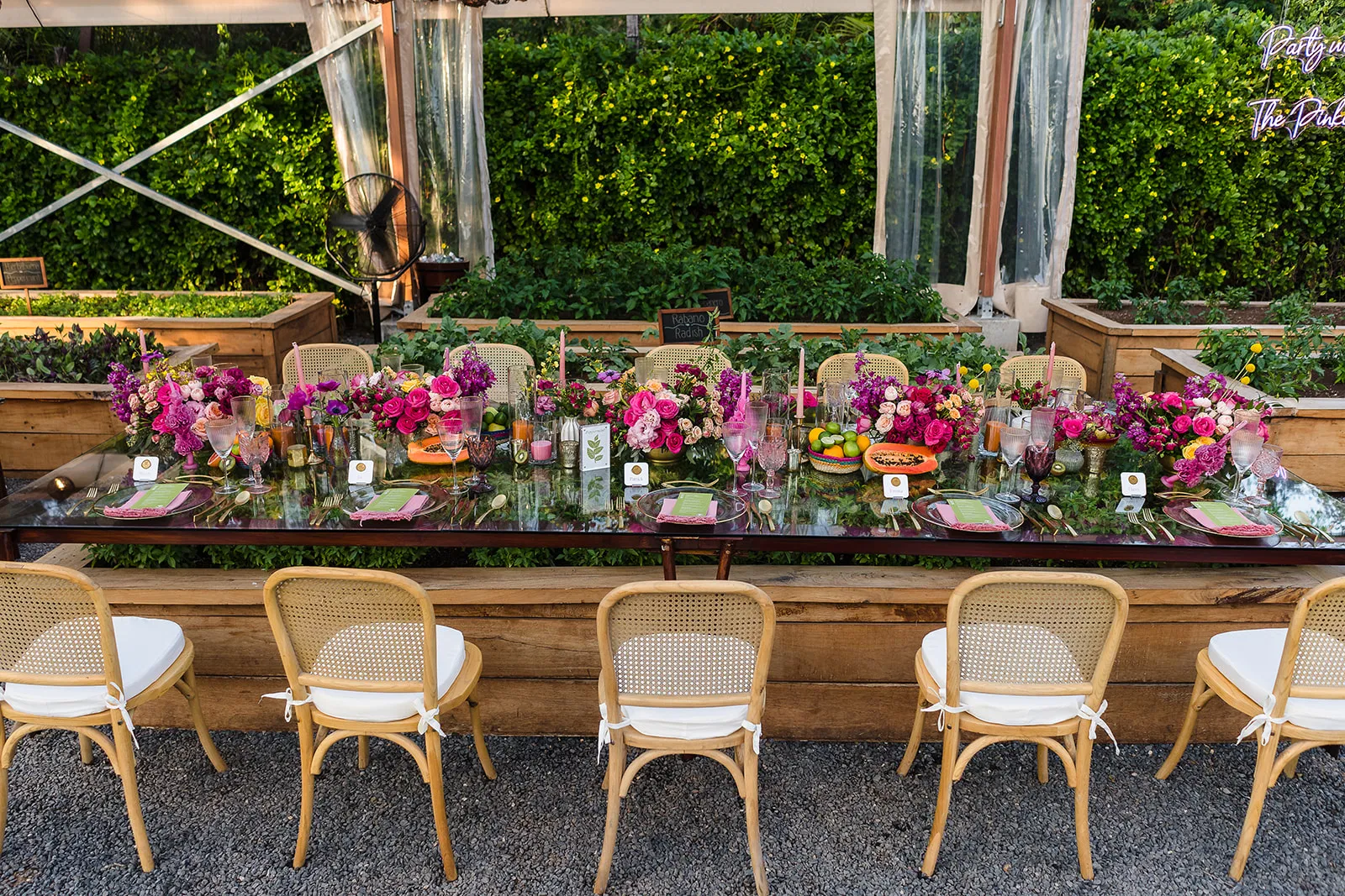 LGBTQ wedding reception table at Rosewood Mayakoba with vibrant florals and rattan chairs in Riviera Maya Mexico