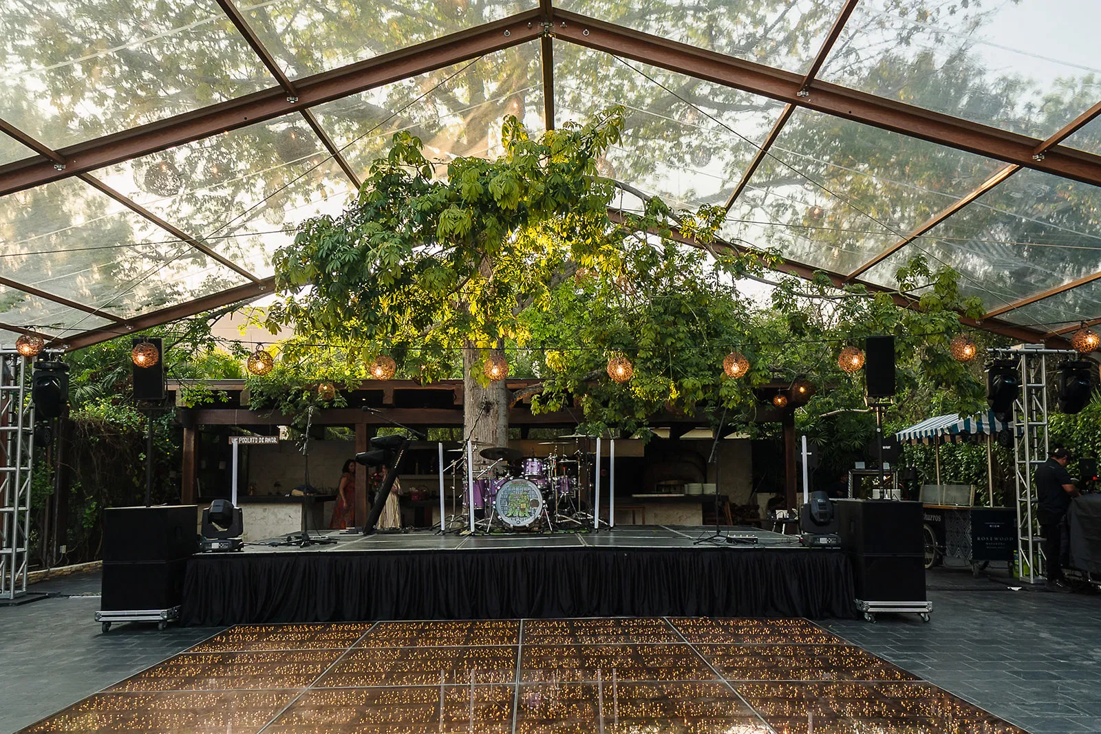 LGBTQ wedding stage setup at Rosewood Mayakoba with clear tent, string lights, and tropical greenery in Riviera Maya Mexico