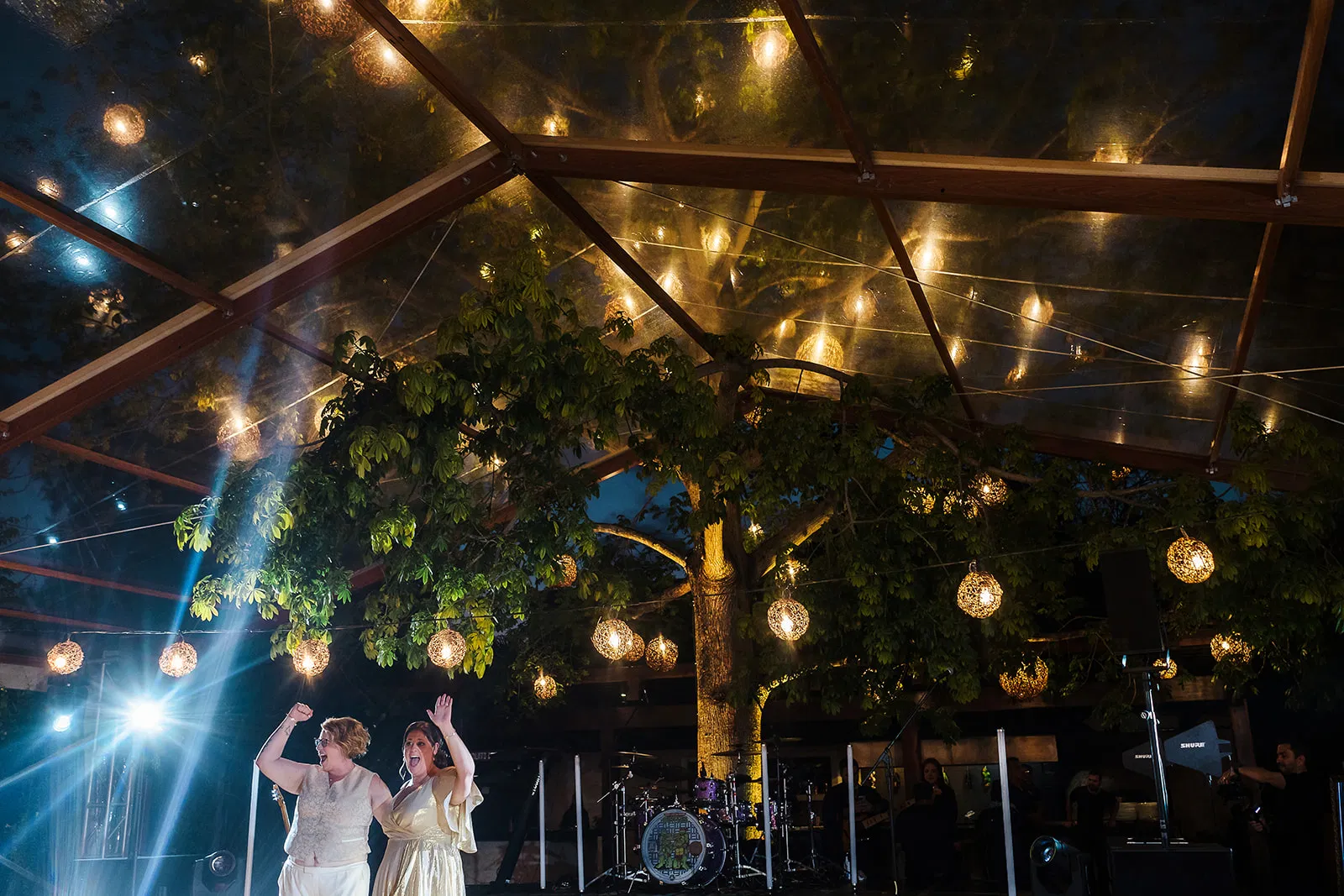 Two brides celebrating at Rosewood Mayakoba LGBTQ wedding under illuminated glass ceiling in Riviera Maya Mexico