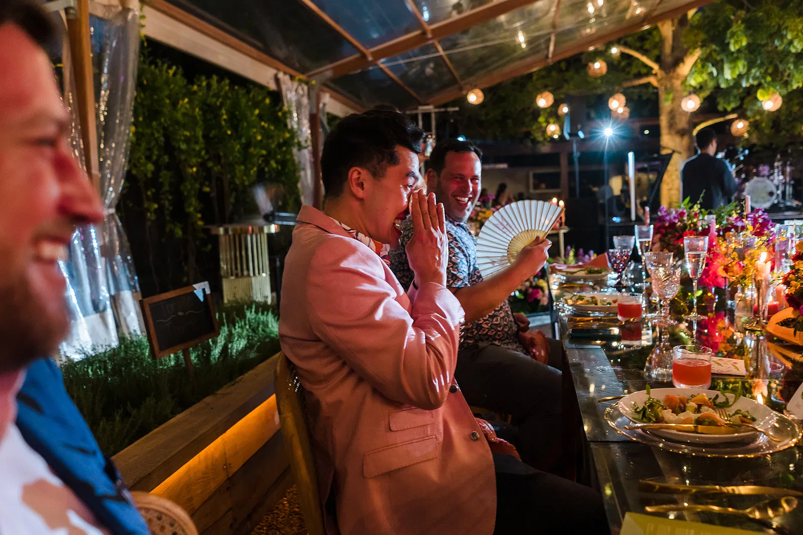 Gay wedding reception at Rosewood Mayakoba with grooms laughing at intimate dinner celebration in Riviera Maya Mexico