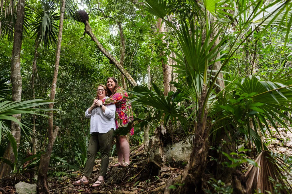 LGBTQ couple embracing in tropical jungle at Rosewood Mayakoba, Riviera Maya Mexico destination wedding photography