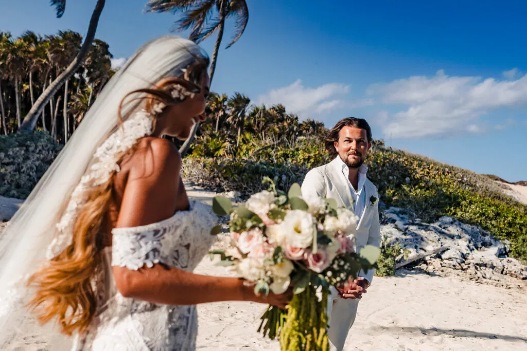 Bride and groom beach wedding ceremony in Tulum Mexico with tropical palm trees and white sand destination wedding photography