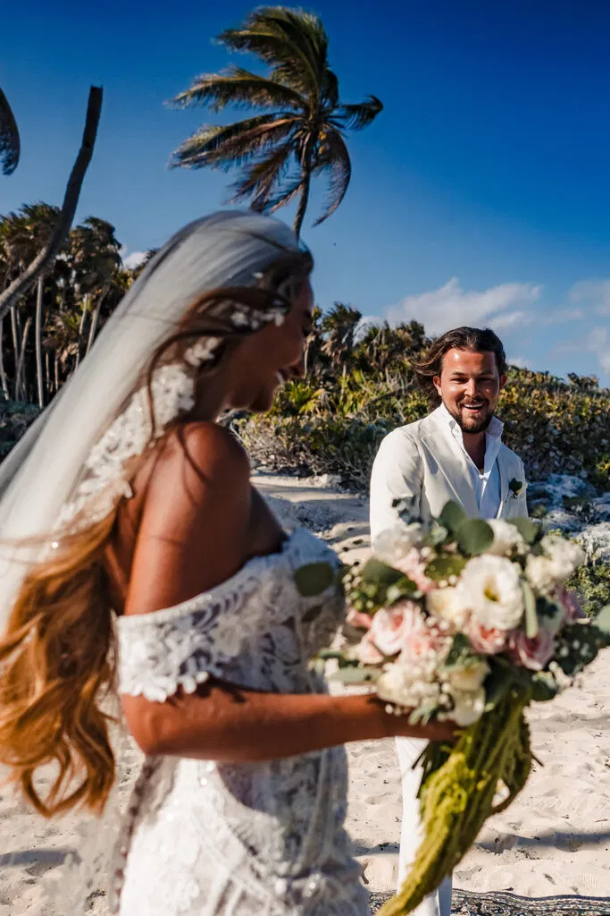 Bride and groom beach wedding ceremony in Tulum Mexico with palm trees and tropical destination wedding photography